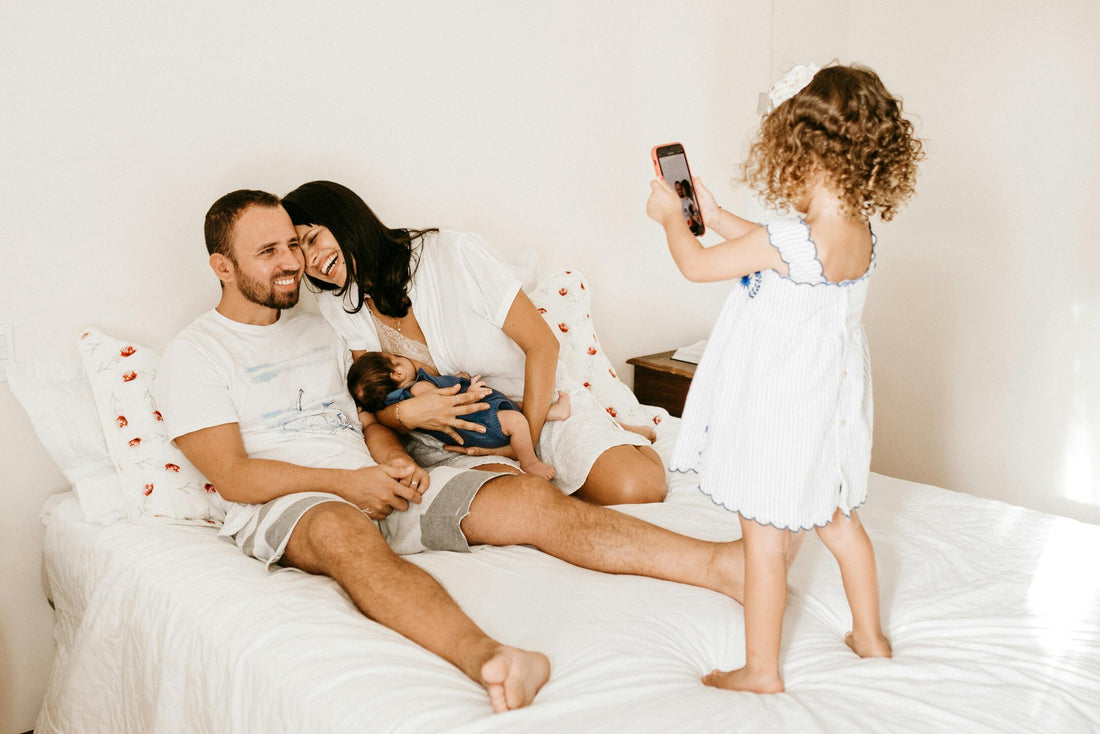 Mother breastfeeding in family