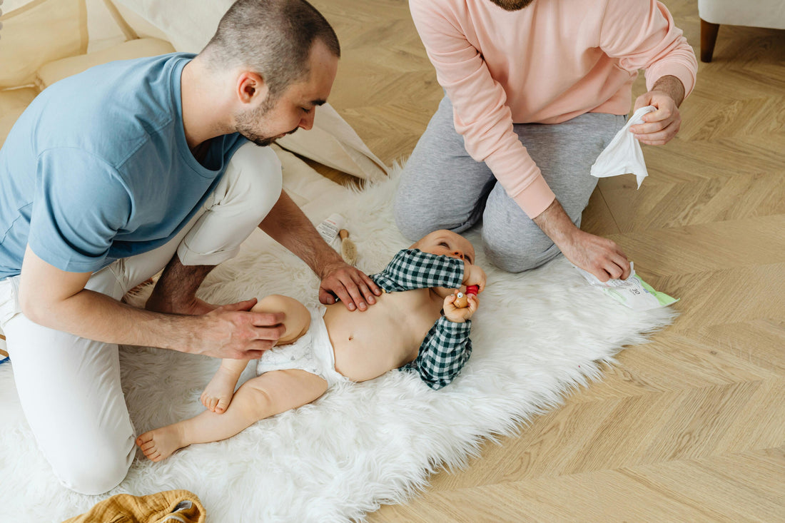 Parents changing baby diapers